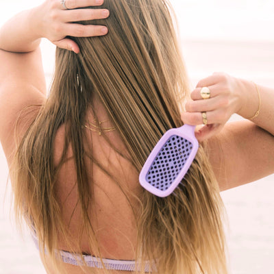 Model using the UNbrush Pastel Detangling Hair Brush in Lilac Purple in hair