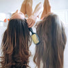 Two models posing with the UNbrush Detangling Hair Brush in Sun Ceremony Yellow